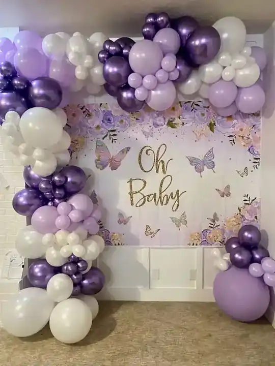Purple, lilac and white balloon garland around an Oh Baby shower backdrop