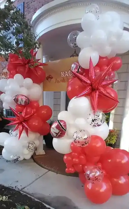 Red, white and silver balloon garland with foil stars at a front entry