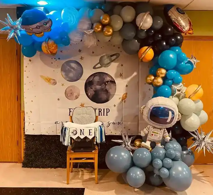 Outer-space balloon garland with planet balloons and an astronaut