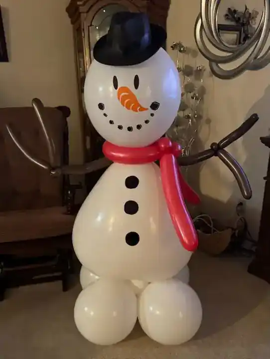 Balloon snowman with a black top hat and red scarf