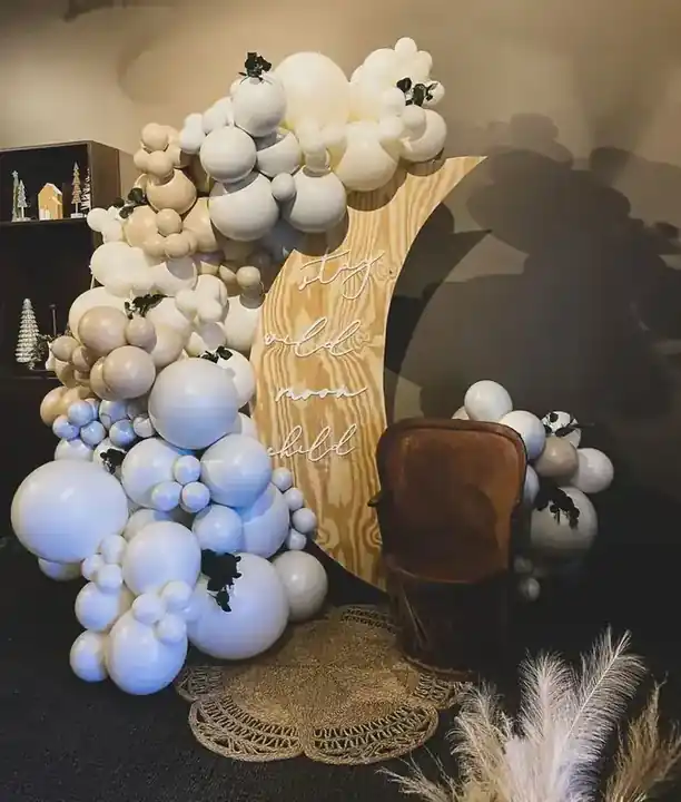 Cream, grey and black balloon garland around a crescent moon backdrop