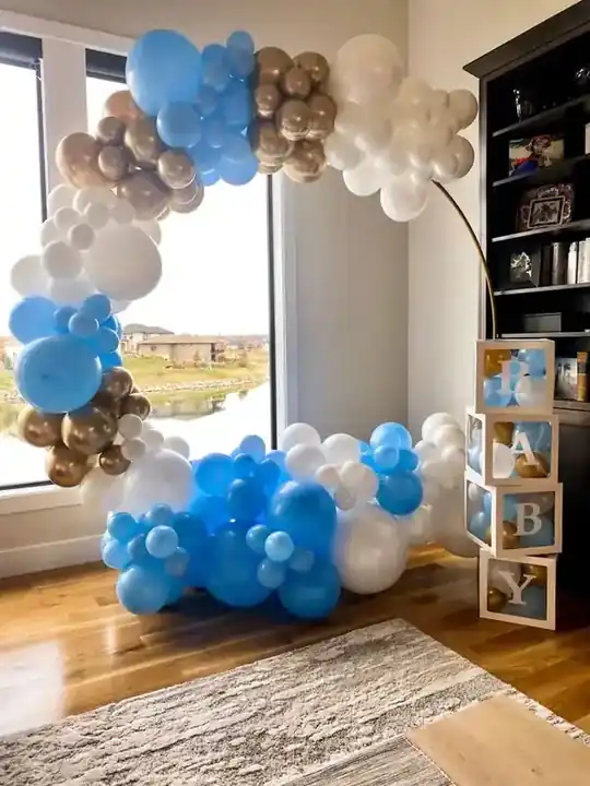 Blue, white and gold balloon garland around a tall window