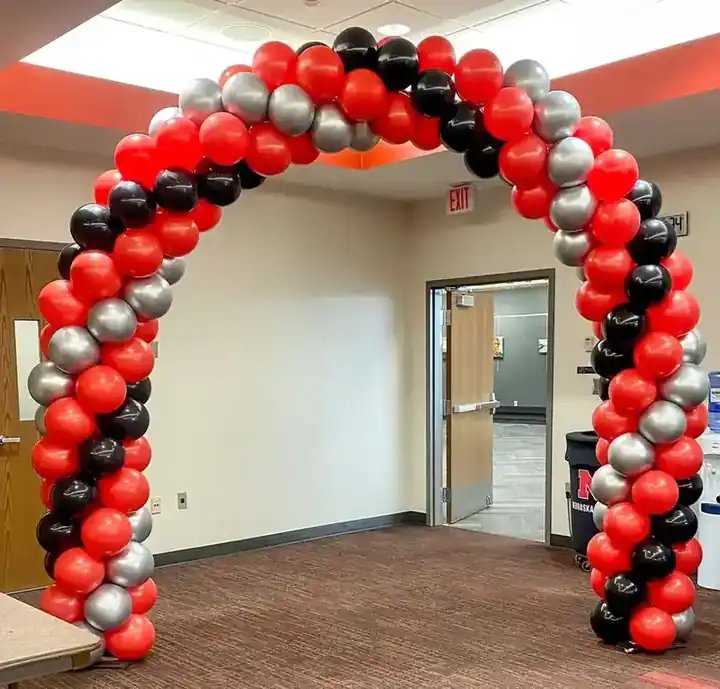 Red, black and silver spiral balloon arch in an office lobby