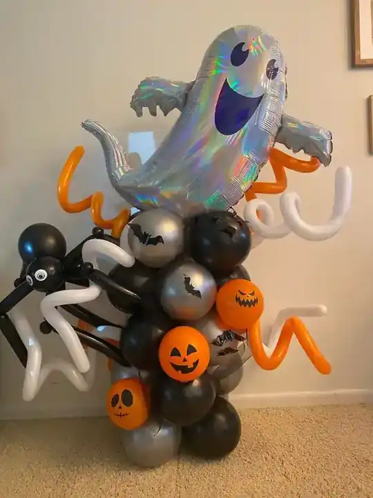 Silver ghost and black balloon Halloween sculpture with pumpkin balloons