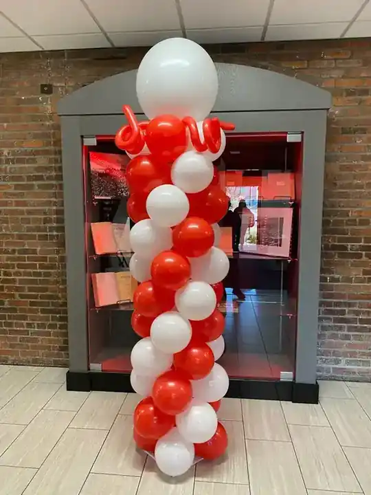 Red and white spiral balloon column in a doorway